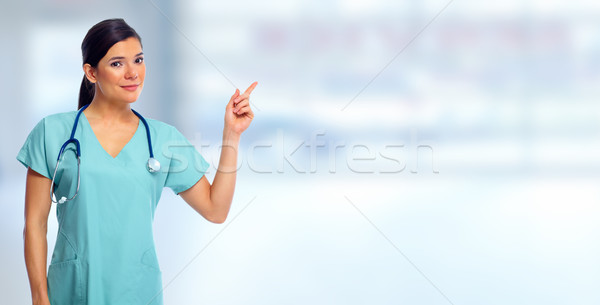 Doctor woman showing advertising space. Stock photo © Kurhan