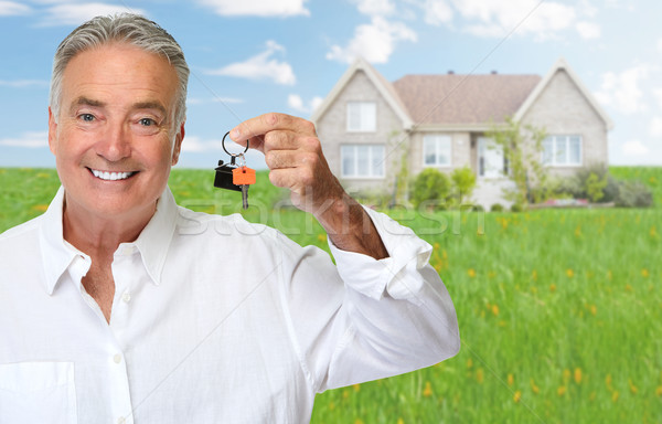 Senior man with house key. Stock photo © Kurhan
