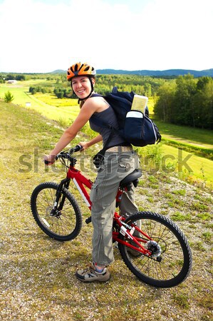 верховая езда молодые улыбающаяся женщина Велоспорт парка девушки Сток-фото © Kurhan