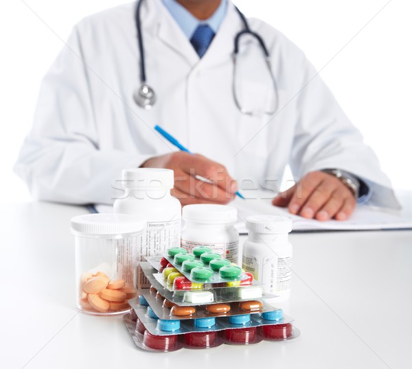 Stock photo: Doctor writing medical prescription.