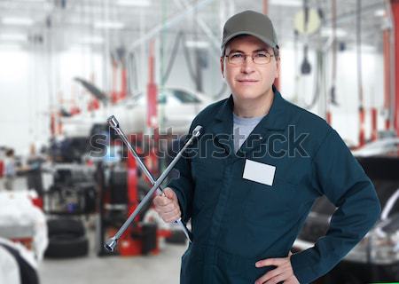 Car mechanic  with tire wrench. Stock photo © Kurhan