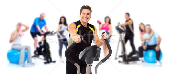 Man exercising on elliptical trainer. Stock photo © Kurhan
