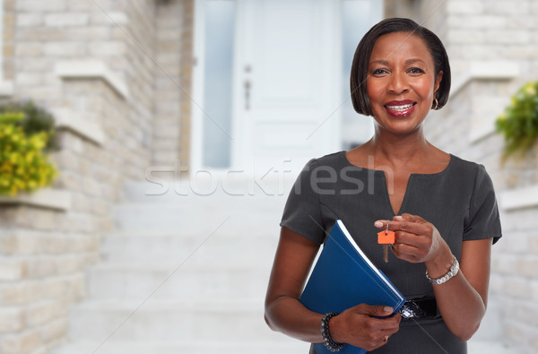 African-American realtor woman with key. Stock photo © Kurhan