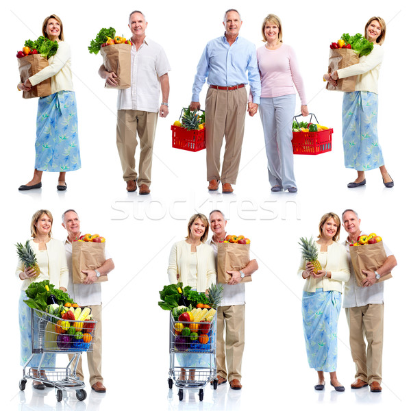 Stock photo: Senior couple with grocery cart.