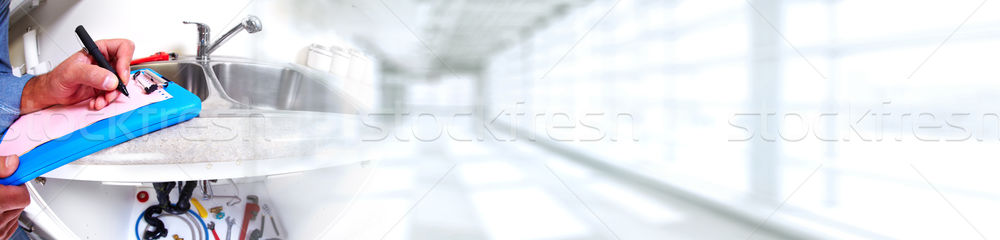 Hand of Plumber with a wrench. Stock photo © Kurhan