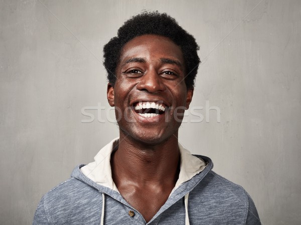 Feliz homem negro sorridente africano americano homem cinza Foto stock © Kurhan