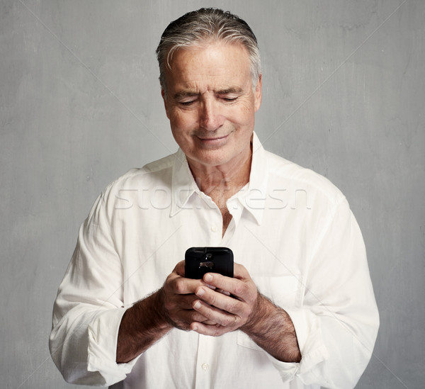 Souriant supérieurs homme smartphone téléphone [[stock_photo]] © Kurhan