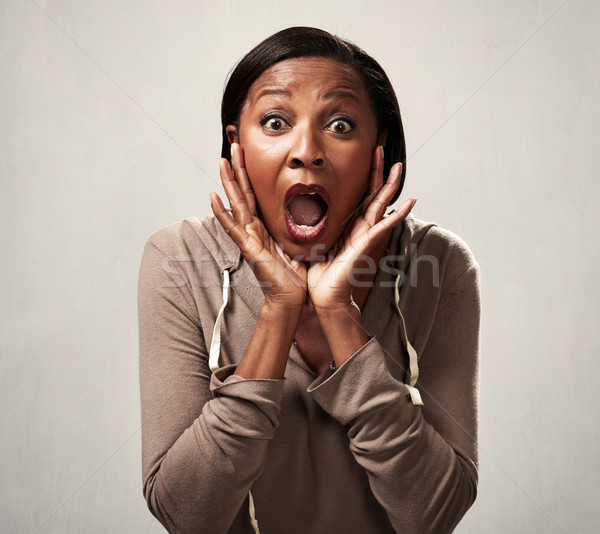 Happy surprised black woman Stock photo © Kurhan