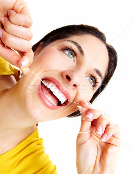 Beautiful woman with a dental floss. Stock photo © Kurhan