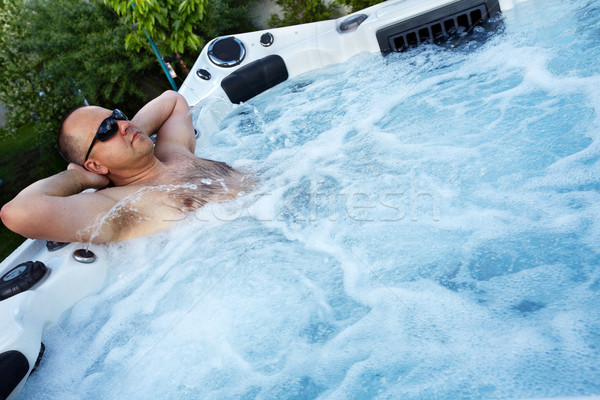 Man massage hot tub spa jacuzzi water Stockfoto © Kurhan
