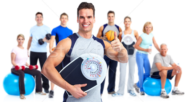 Stock photo: Man with scales over white background.