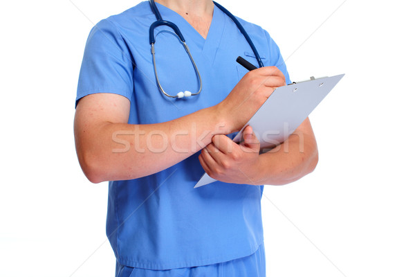 Hands of doctor with clipboard. Stock photo © Kurhan