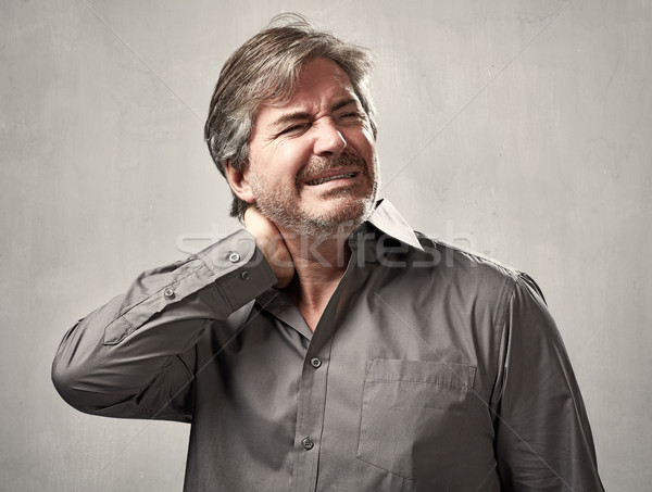 Baş ağrısı bunalımlı adam gri duvar yüz Stok fotoğraf © Kurhan