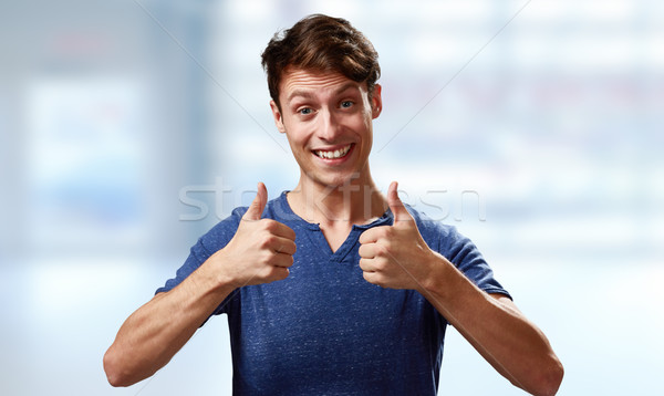 Happy young man with thumbs Stock photo © Kurhan