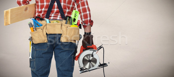 Builder handyman with electric saw. Stock photo © Kurhan
