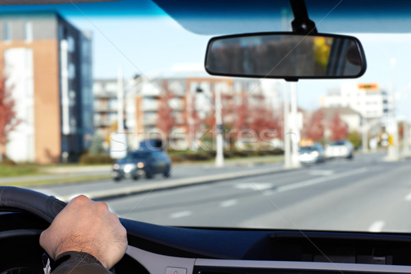 Hand of man driving on a highway. Stock photo © Kurhan