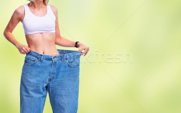 Slimming woman wearing big pants. Stock photo © Kurhan