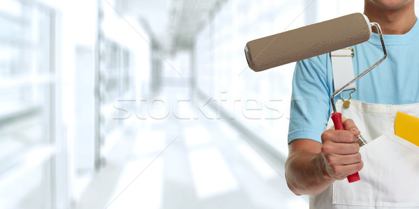 Painter hand with painting roller Stock photo © Kurhan