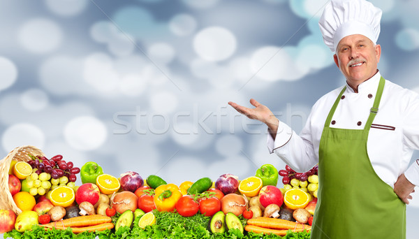 Chef man with fruits and vegetables. Stock photo © Kurhan