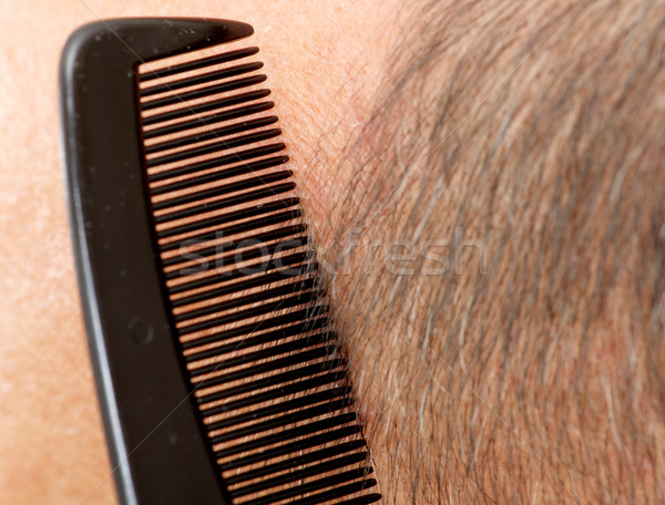 Stock photo: Man head with a comb.