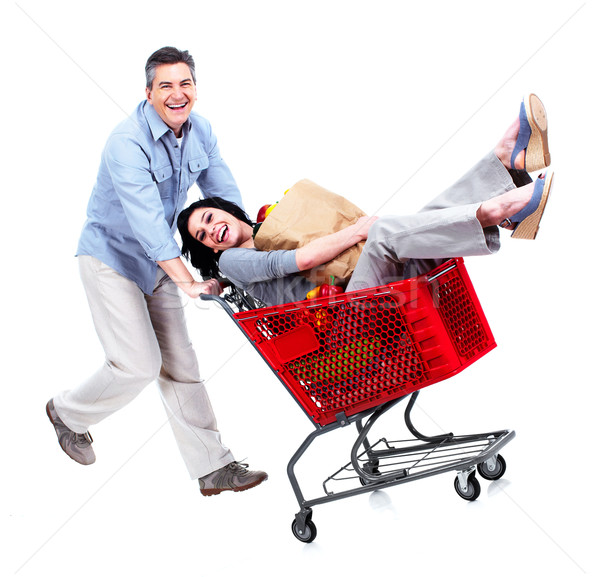 Happy couple with a grocery shopping cart. Stock photo © Kurhan