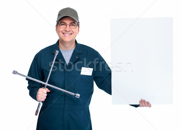 Stock photo: Auto mechanic with a wheel wrench.