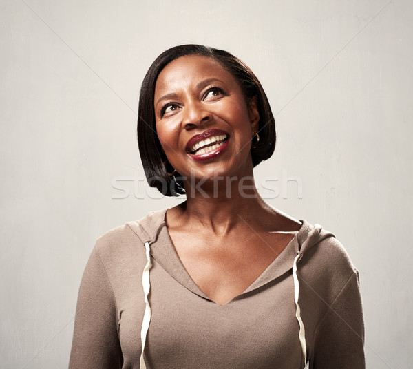 Thinking smiling african woman Stock photo © Kurhan
