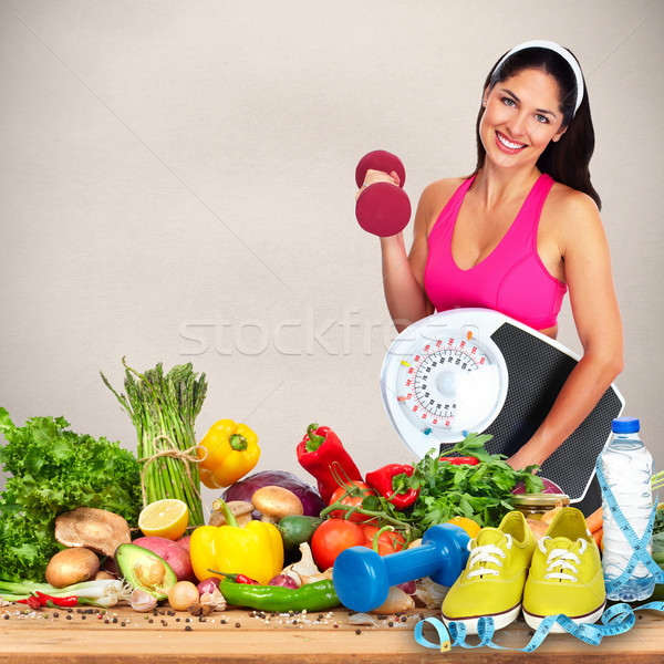 Woman with scales and dumbbell Stock photo © Kurhan