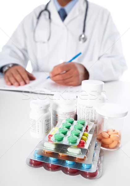 Stock photo: Doctor writing medical prescription.