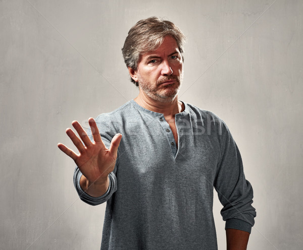 Desaprovação homem retrato gesto cinza parede Foto stock © Kurhan