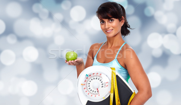 Young asian woman with apple and scales. Stock photo © Kurhan