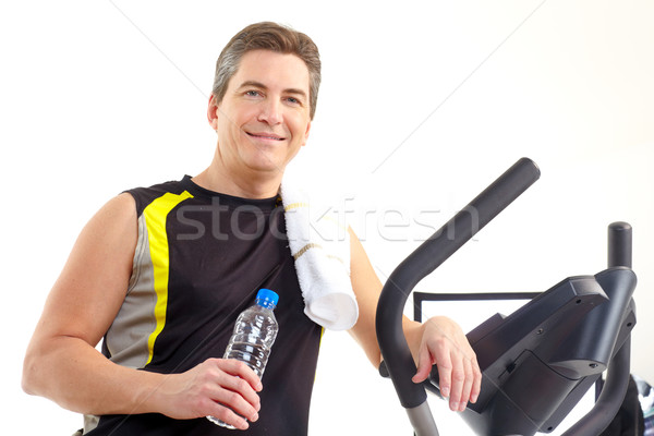Smiling mature strong man working out. Isolated over white background
 Stock photo © Kurhan