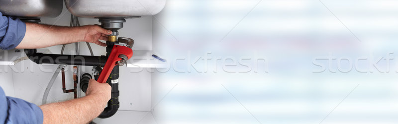 Hands of Plumber with a wrench. Stock photo © Kurhan