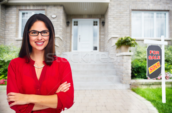 Real Estate agent woman near new house. Stock photo © Kurhan