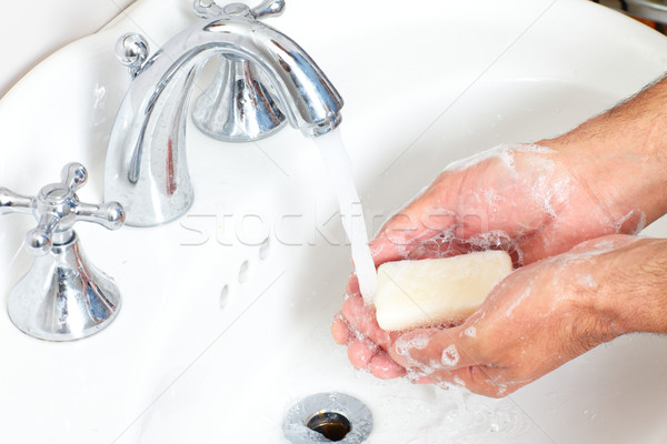 Man washing hands with soap and water. Stock photo © Kurhan