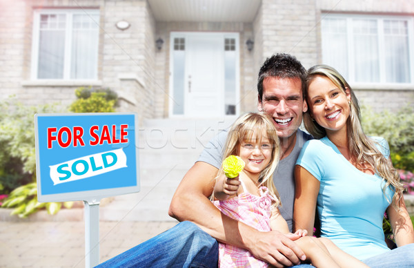 Happy family near new house. Stock photo © Kurhan