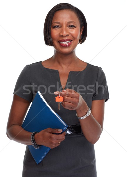 Stock photo: African-American realtor woman with key.