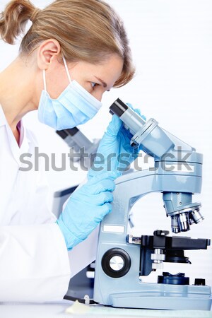 Chinese scientist woman with microscope. Stock photo © Kurhan