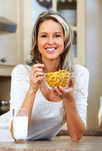 Young woman eating cereals. Stock photo © Kurhan