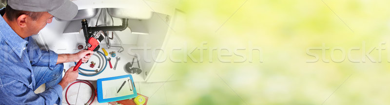 Hand of Plumber with a wrench. Stock photo © Kurhan