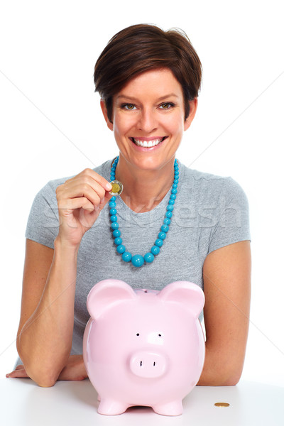 Stock photo: Elderly woman with piggy bank.