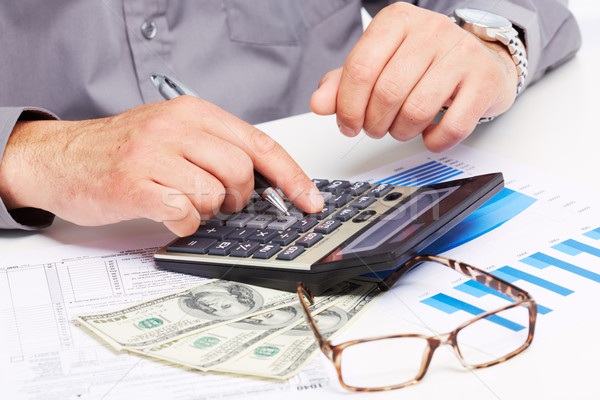 Hands of businessman with calculator. Stock photo © Kurhan