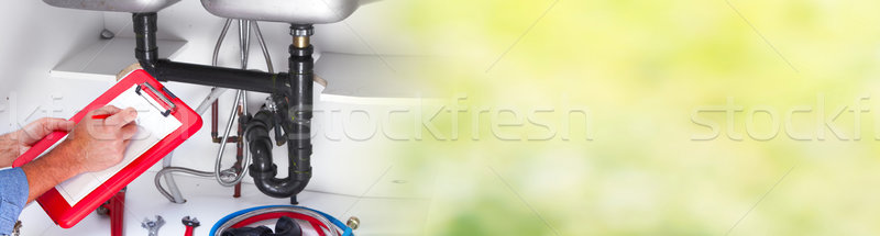 Hand of Plumber with a wrench. Stock photo © Kurhan