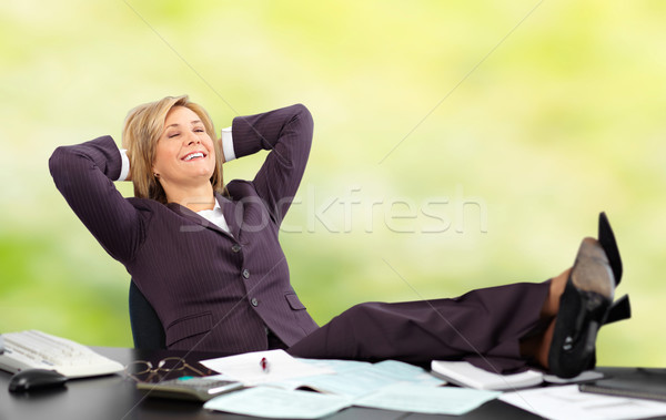 Relaxing mature business woman. Green background Stock photo © Kurhan