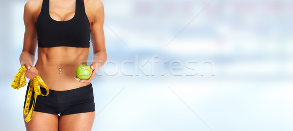 Woman abdomen with measuring tape and apple. Stock photo © Kurhan