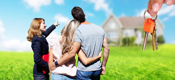 Real Estate agent woman with clients near new house. Stock photo © Kurhan