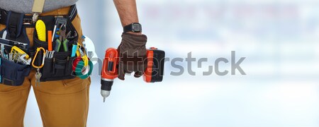 Hand of handyman with a tool bag. Stock photo © Kurhan