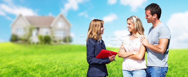 Real Estate agent woman with clients near new house. Stock photo © Kurhan