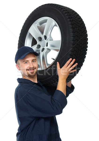 Car mechanic with a tire. Stock photo © Kurhan