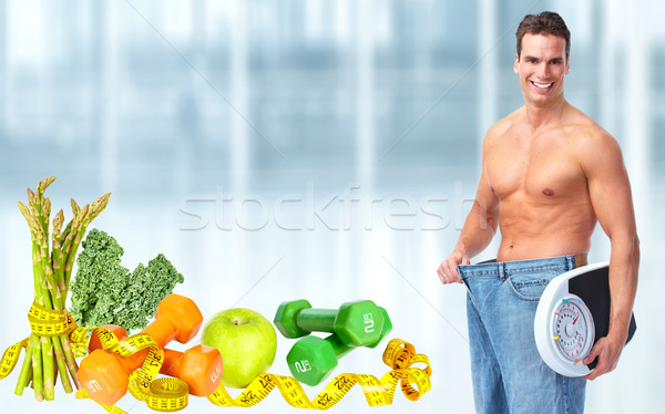 Stock photo: Slimming man wearing big jeans.